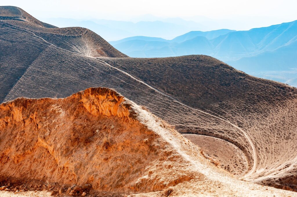 Mountain trails in the barren multi-peaked mountains in winter in Gansu province, northwest China