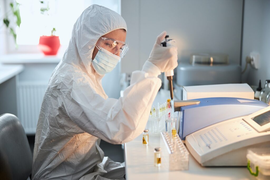 Scientist in a hazmat suit conducting research on a highly pathogenic coronavirus