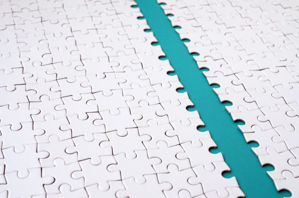 The blue path is laid on the platform of a white folded jigsaw puzzle