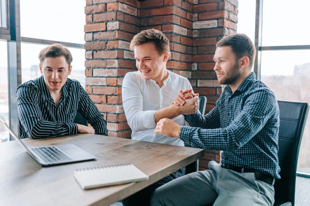 Three men using their laptops to improve their productivity and success at work