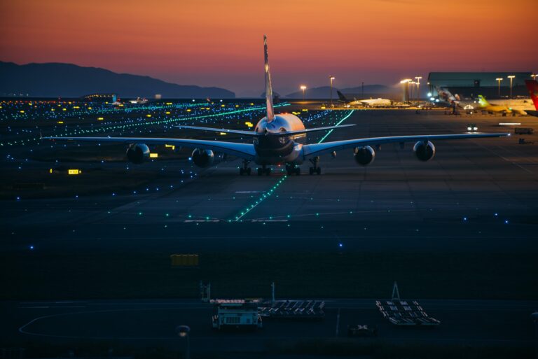 Airplane on the track at sunset time