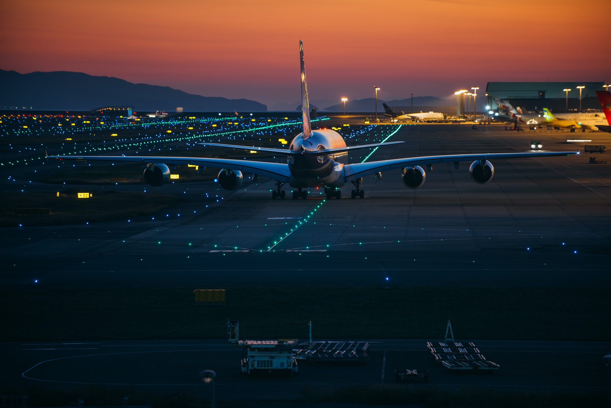 Airplane on the track at sunset time