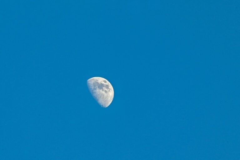 Beautiful half-moon in the blue sky-background