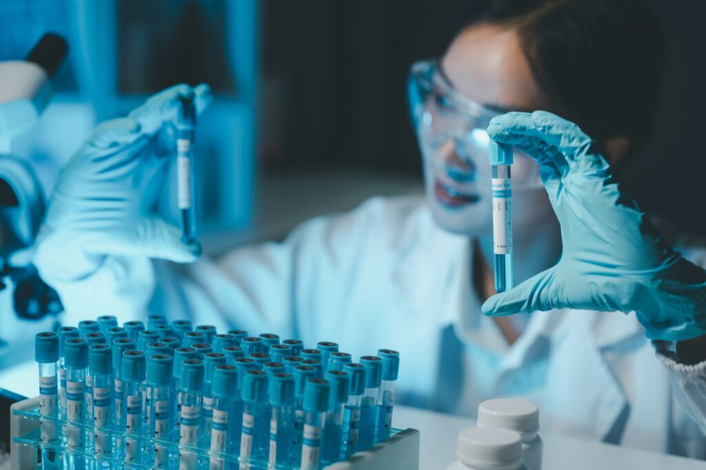 biochemical research scientist working with microscope for coronavirus vaccine development in, Portr