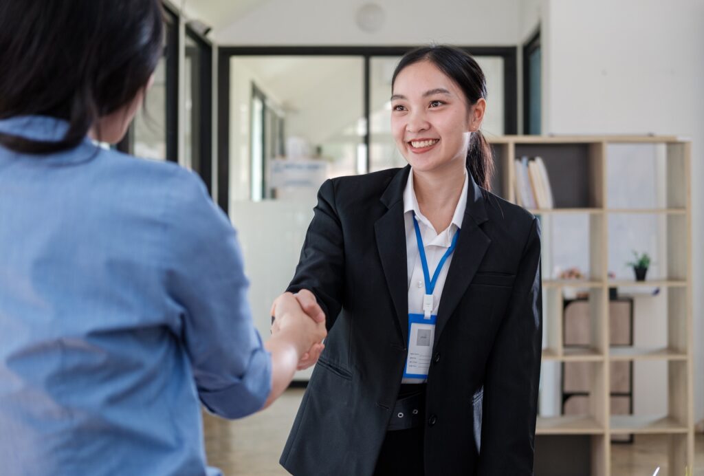 Businesswoman making handshake with a businessman greeting, dealing, merger and acquisition concepts