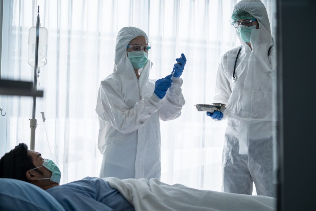 Caucasian doctor holding vaccine shot for diseases outbreak vaccination to patient in hospital.