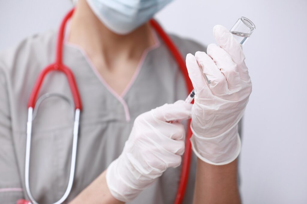 Doctor, nurse in medical mask, stethoscope and gloves holding flu, measles, coronavirus,