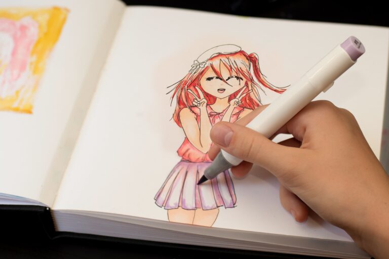 Girl's hand drawing anime manga sketch with alcohol based sketch markers.