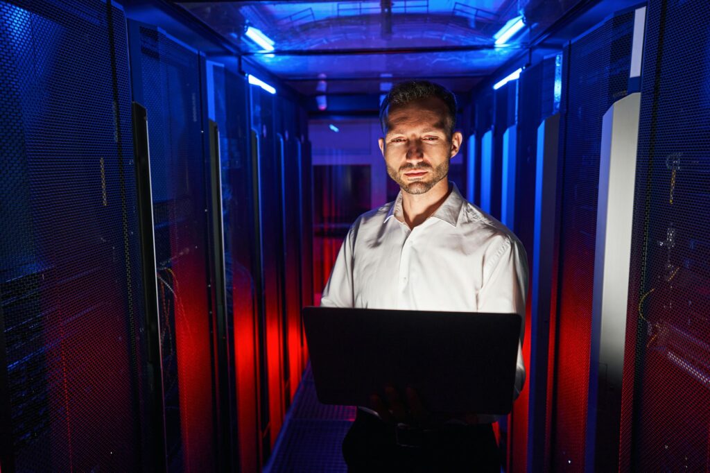 IT engineer working with laptop in data storage center