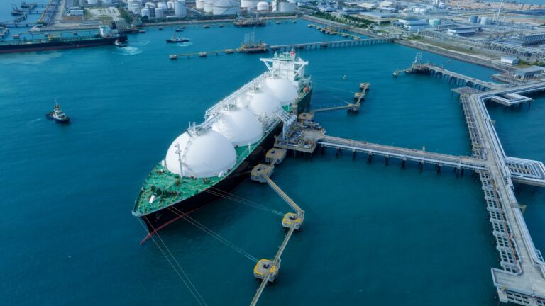 LNG (Liquified Natural Gas) tanker anchored in Gas terminal gas tanks for storage. Oil Crude Gas