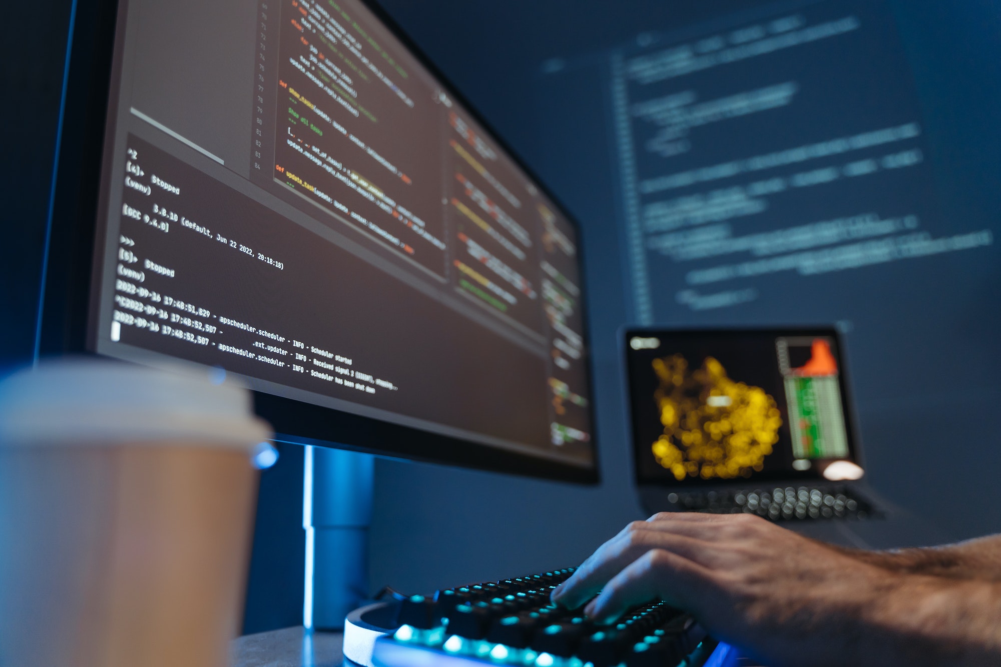 No face picture of software engineer hands typing and composing app script in front of pc screen