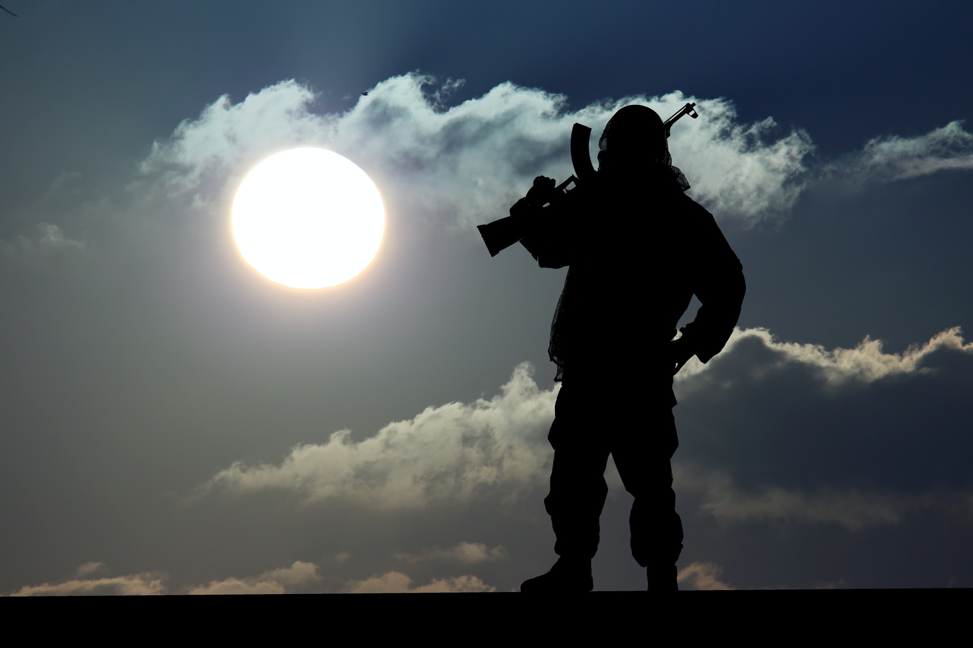 Silhouette of military soldier with weapon