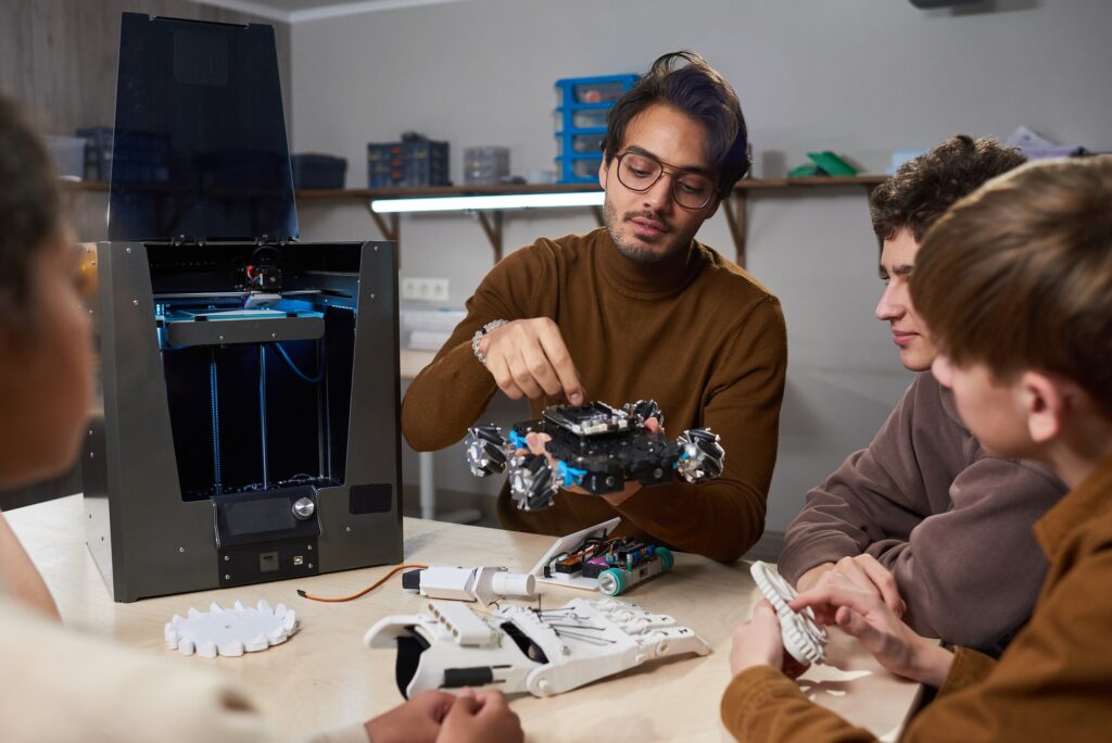 Teacher building a robotic machine at science school