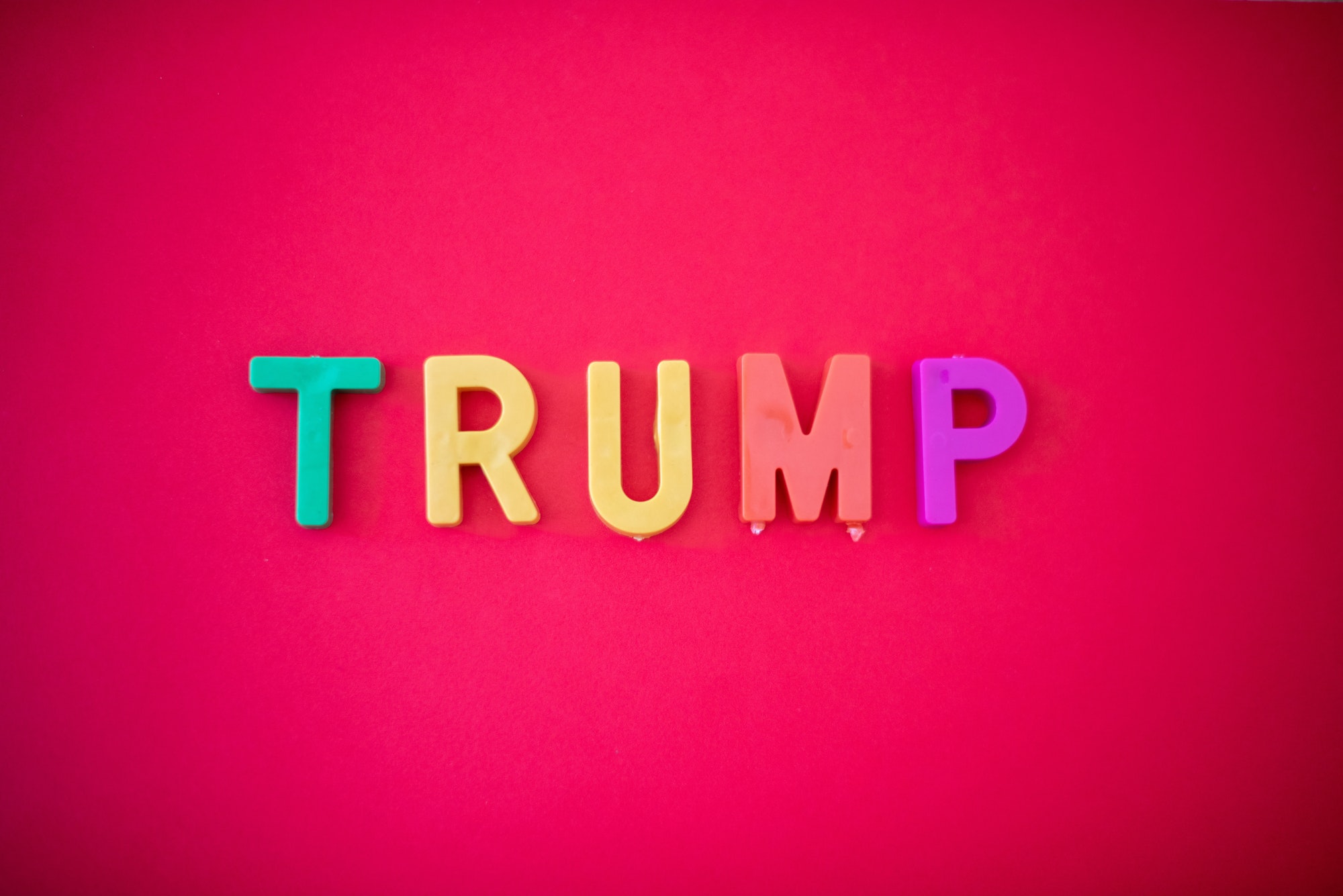 The word TRUMP isolated against red background shot from directly above