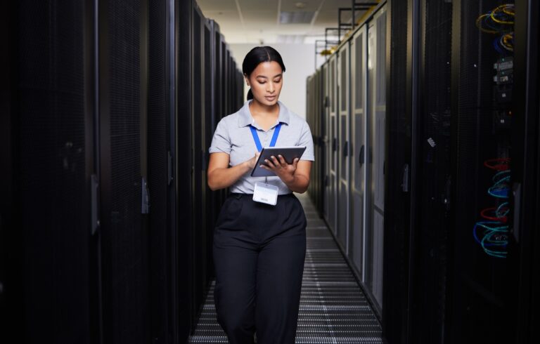 Woman, tablet and engineer in server room on research for programming at night. Information technol