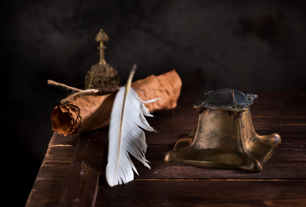 Ancient Inkwell, feather pen and old paper with a seal