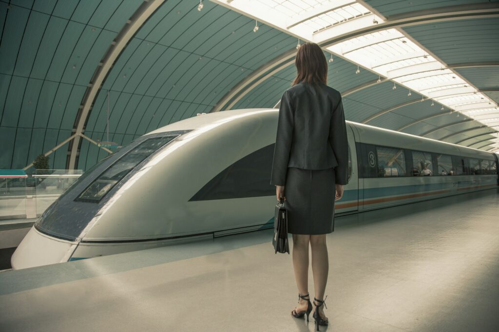 Business woman waiting for a train on railway platform, Shanghai, China