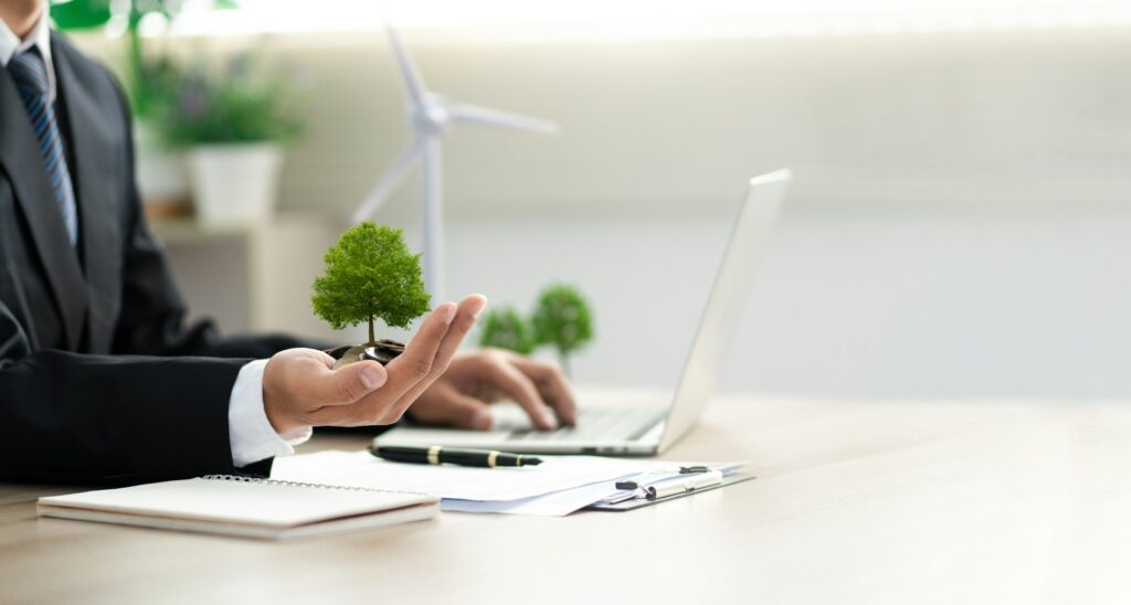 Businessman holding a green tree with esg icon. Concept of esg, environmental