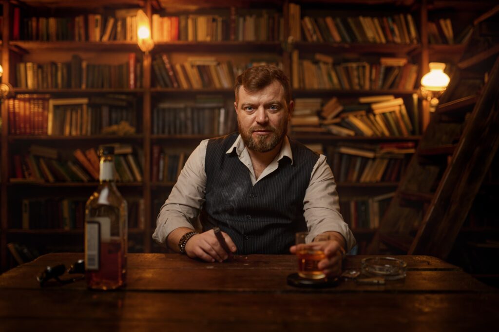 Businessman smokes cigarette and drinks alcohol