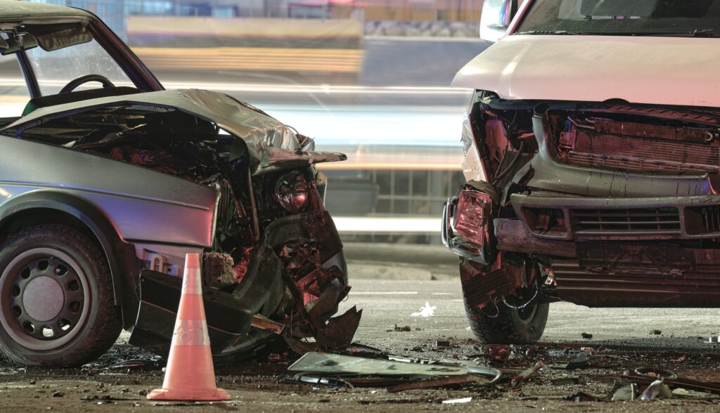 Cars crashed heavily in road accident after collision on city street at night. Road safety and