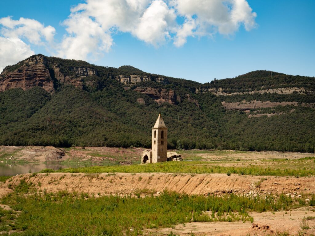 Church in Sau Swamp during the drought. Scarcity of water in Spain, environmental problems.