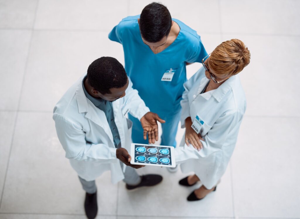 Doctor, tablet and meeting in healthcare above on screen for research, anatomy or surgery analysis.