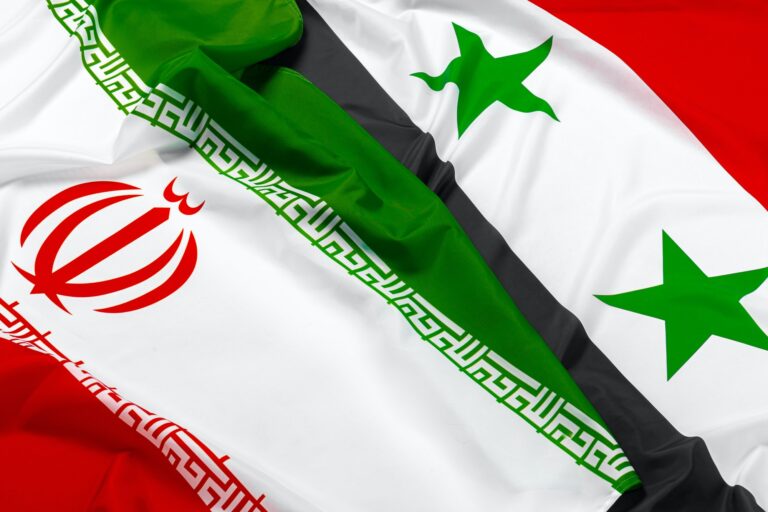 Flags of Syria and Iran together close up