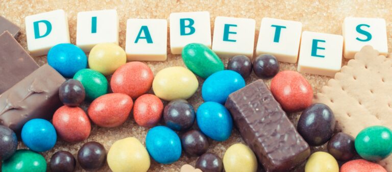 Inscription diabetes and heap of sweets containing a lot of sugar. Reduction eating unhealthy food