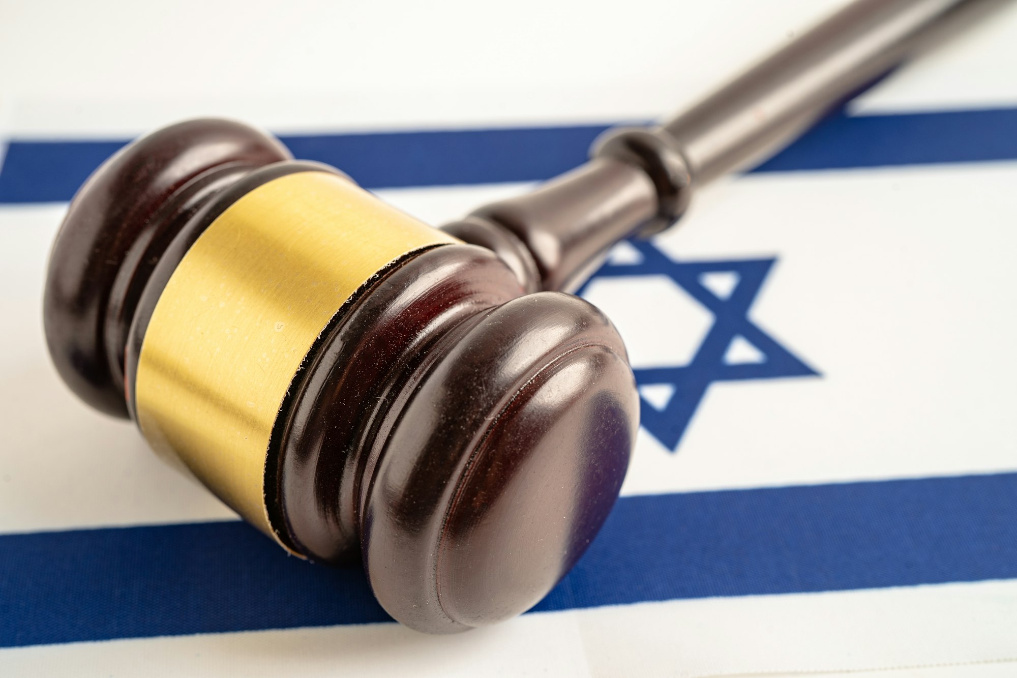 Israel flag with judge hammer, Law and justice court concept.