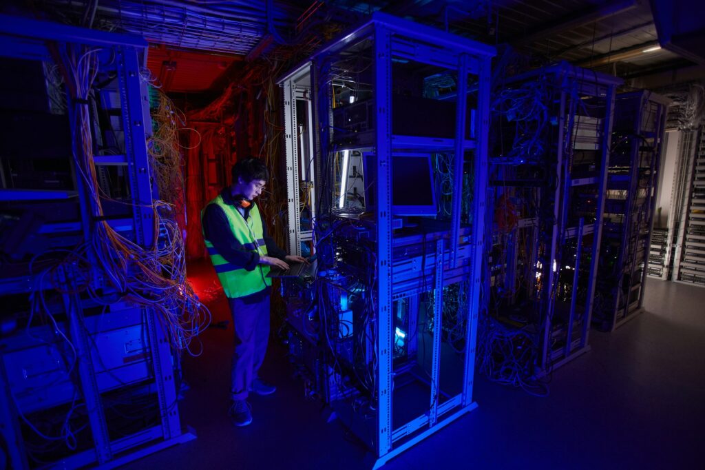 IT Technician Inspecting Server Room