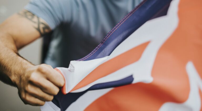 Man showing his fist with UK flag during a protest