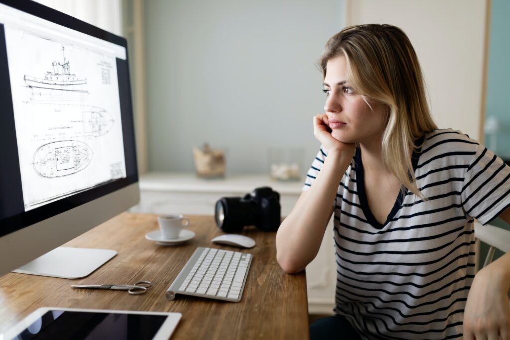 Portrait of young woman designing at home