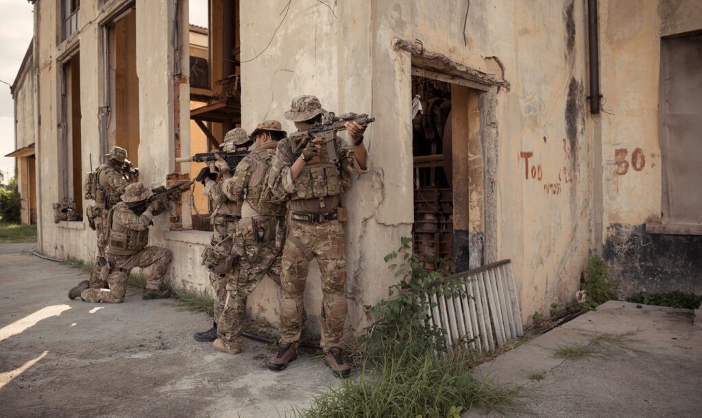 Professional marine soldiers training with weapon on a military range.