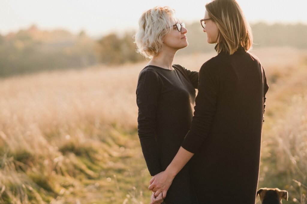 Same-sex caucasian lesbian couple outdoors on the background of beautiful nature.