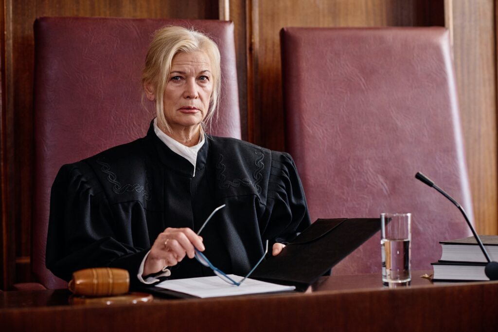 Serious mature blond female judge of supreme court of justice in black mantle