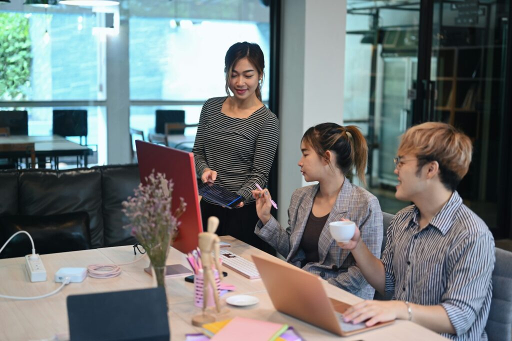 Team of coders brainstorming ideas for developing website design and coding technologies.