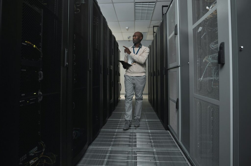 Technician, cybersecurity and man in the server room for data maintenance, it or analysis. System,