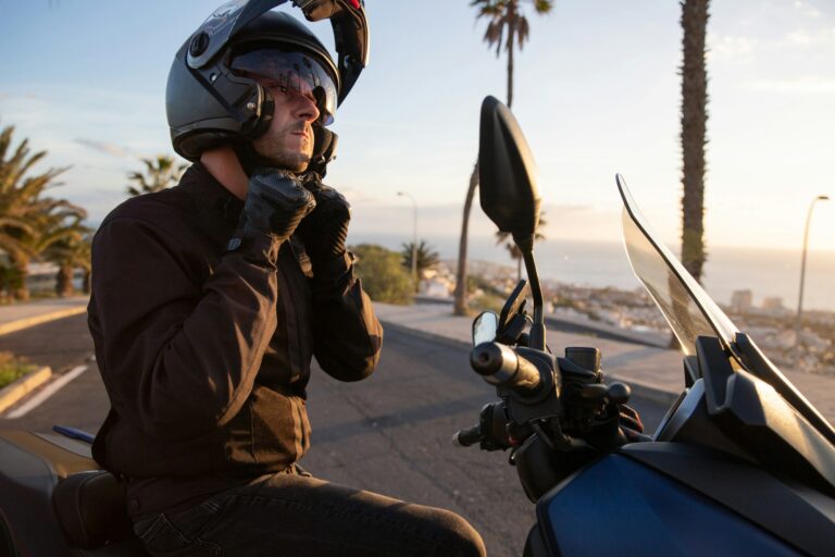 A motorcyclist sitting on his motorcycle is wearing a helmet, driving safety