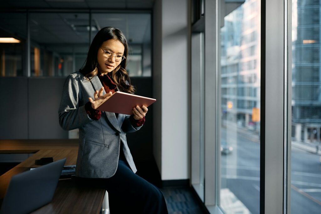 Asian businesswoman working on digital tablet in the office.