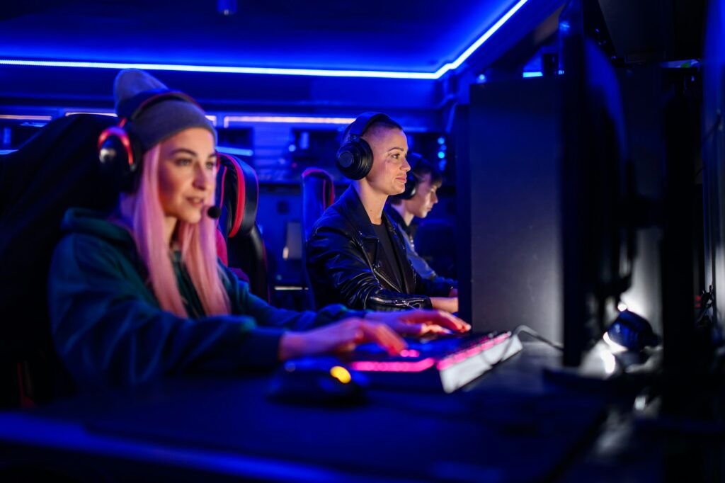 Bald woman gamer in cyber club playing a video game with her team