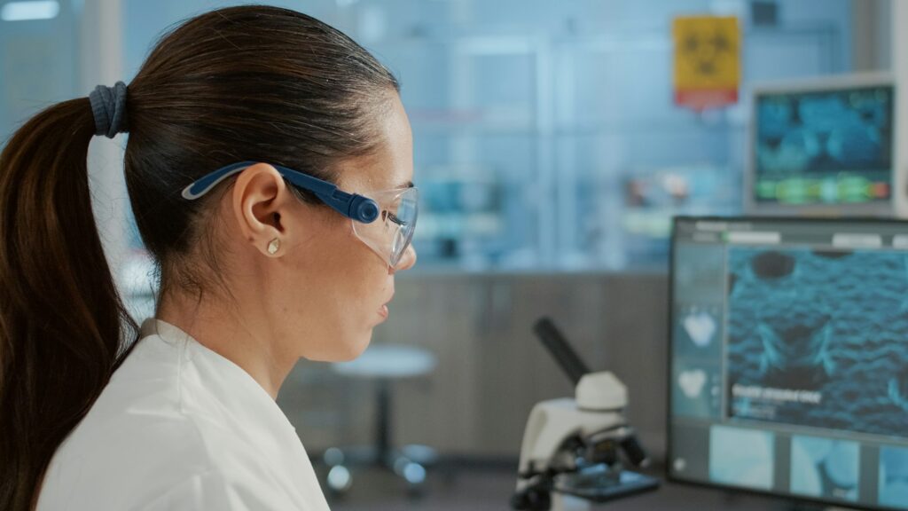 Biology specialist working with computer to examine dna animation