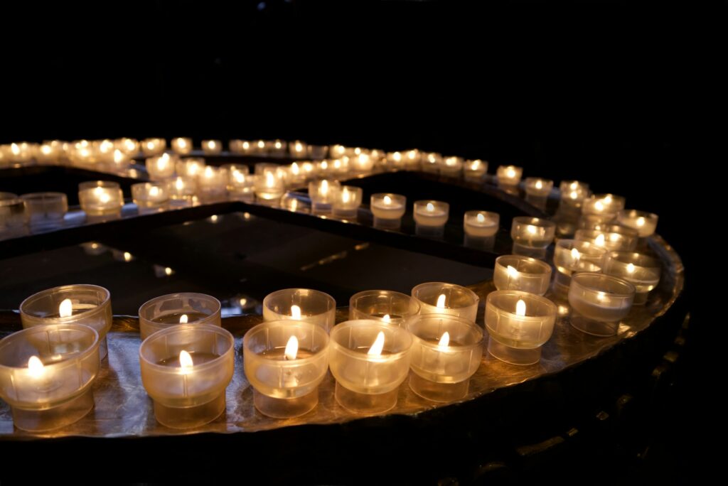 Burning candles on a round stand in the church