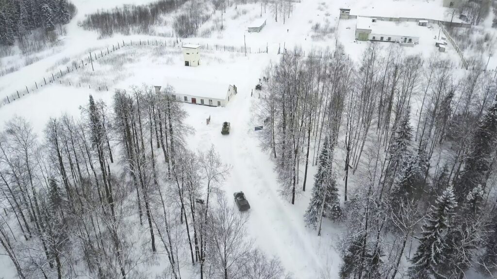 Military armored personnel carriers in the woods during military exercises. Clip. Top view of