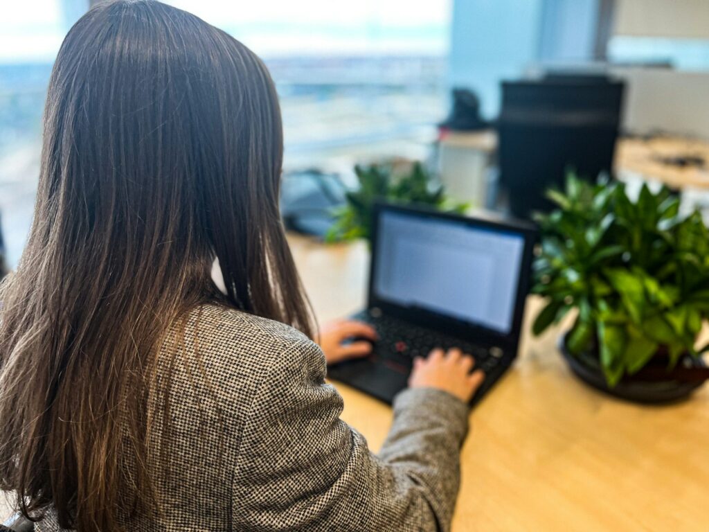 Millennial woman working with her laptop in a modern office, business woman, workplace, technology