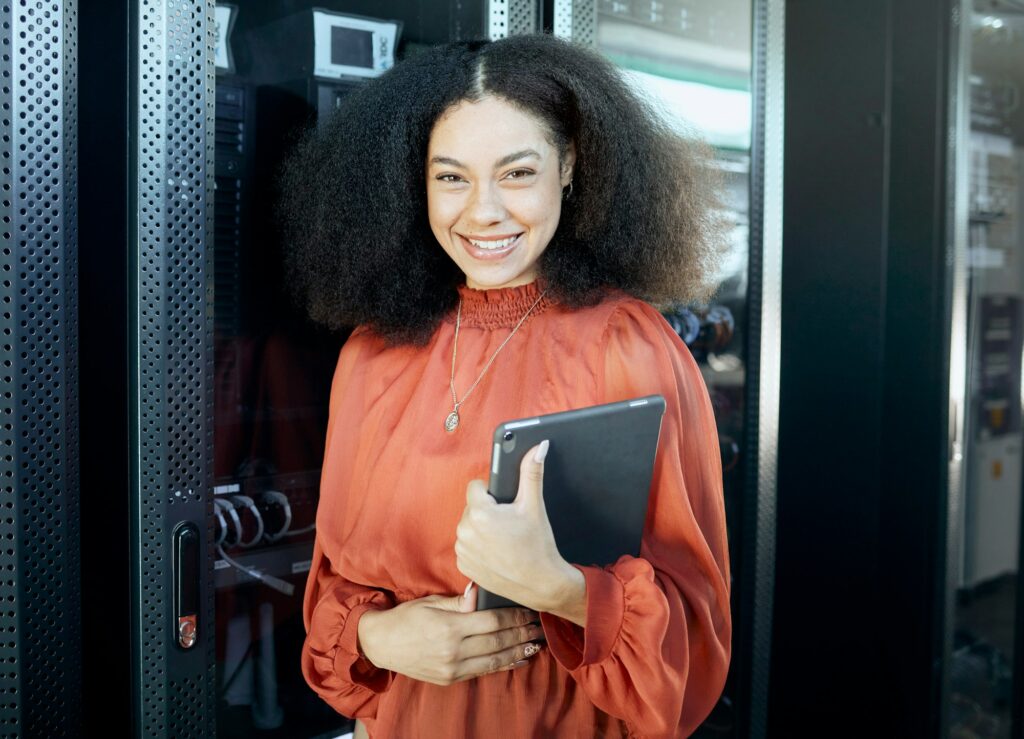 Technology, data and woman with tablet server room with smile in career for future internet innovat