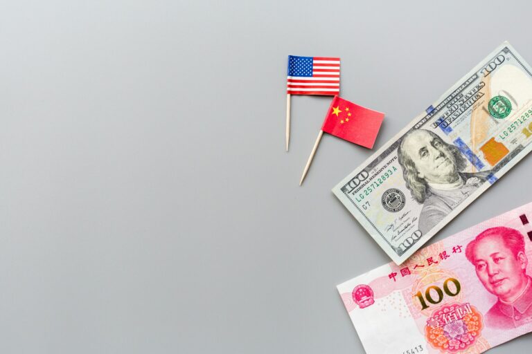 Trade war between China and USA. Chinese yuan and American one hundred dollars and flags