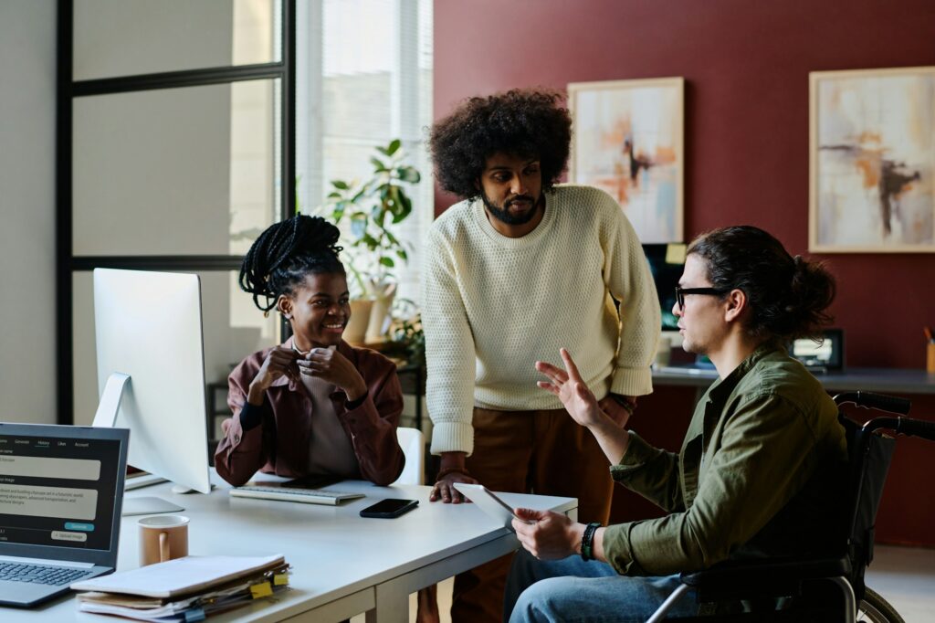 Two colleagues looking at AI designer