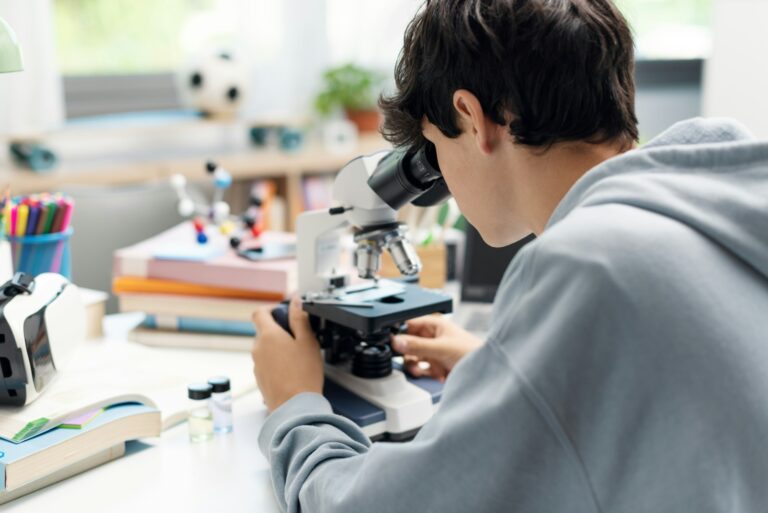 Academic student using a microscope