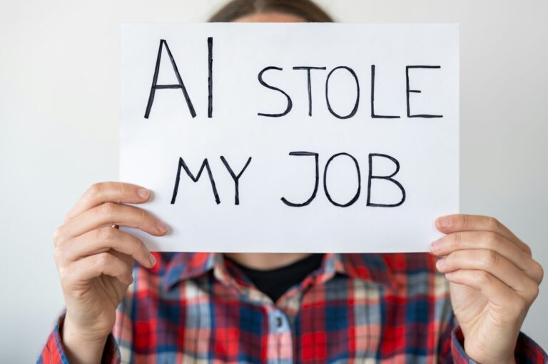 Anonymous person holding sign with inscription "AI stole my job"