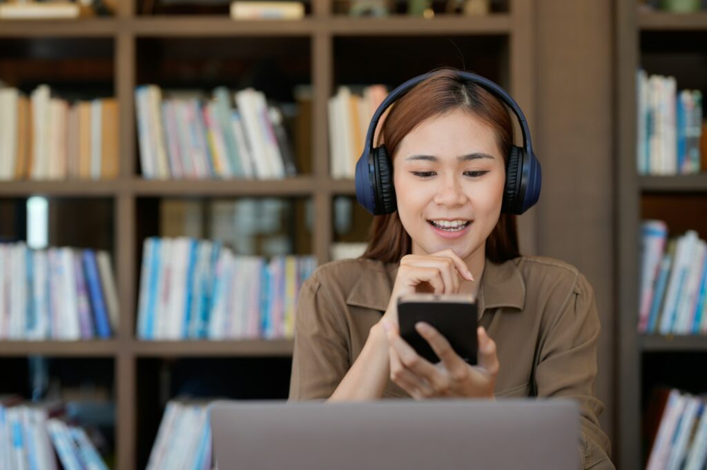 Asian tutor of language start online lesson with trainee wave hand smiling looks at pc screen